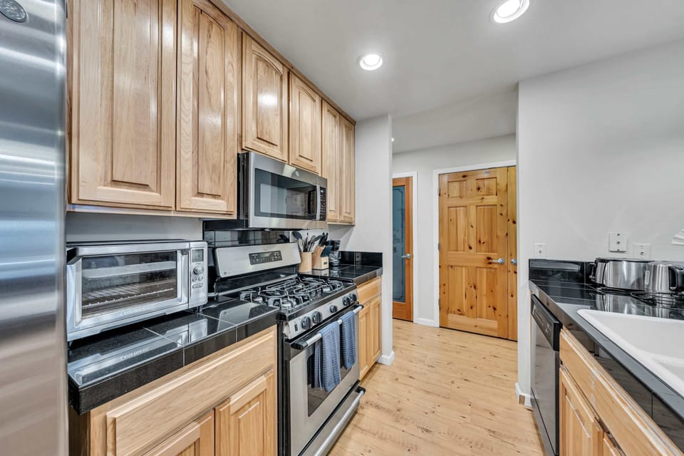 Kitchen: Drip coffee maker, blender, children’s dishes, ample cabinet space, cooking utensils, tableware