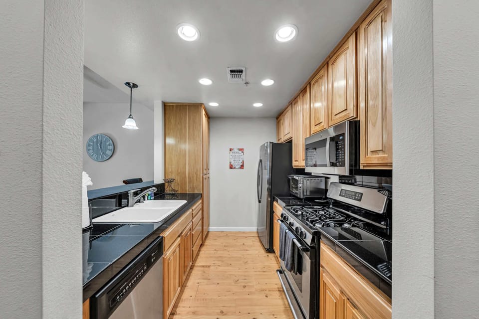 Kitchen: Drip coffee maker, blender, children’s dishes, ample cabinet space, cooking utensils, tableware