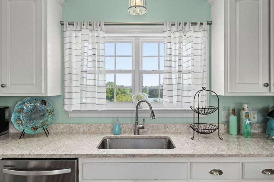 Upgraded and fully stocked kitchen space bathed in natural lighting!