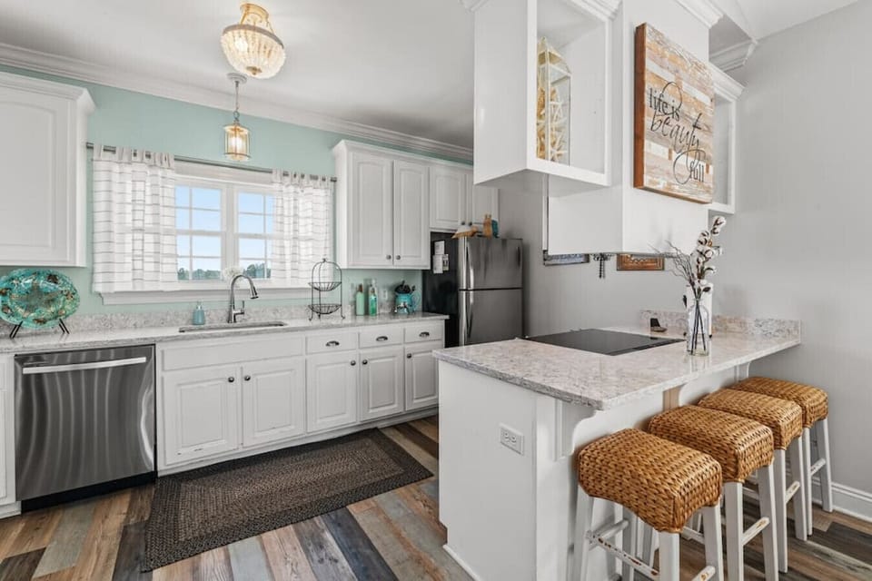 Upgraded and fully stocked kitchen space with breakfast bar!