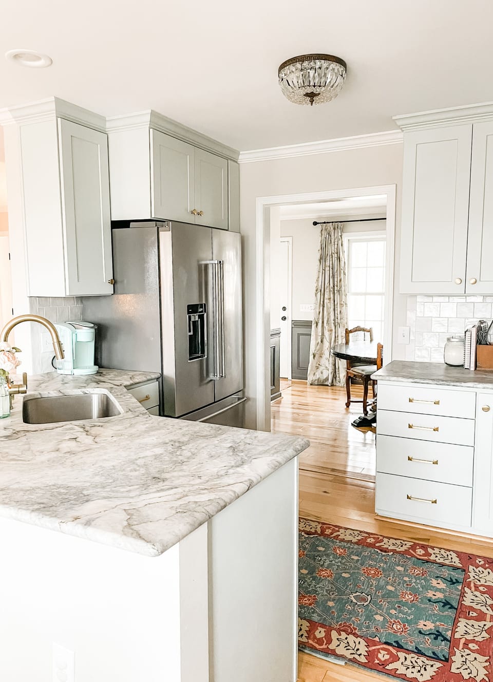 Bright kitchen with marble counters, sleek cabinets, and open flow—perfect for entertaining!