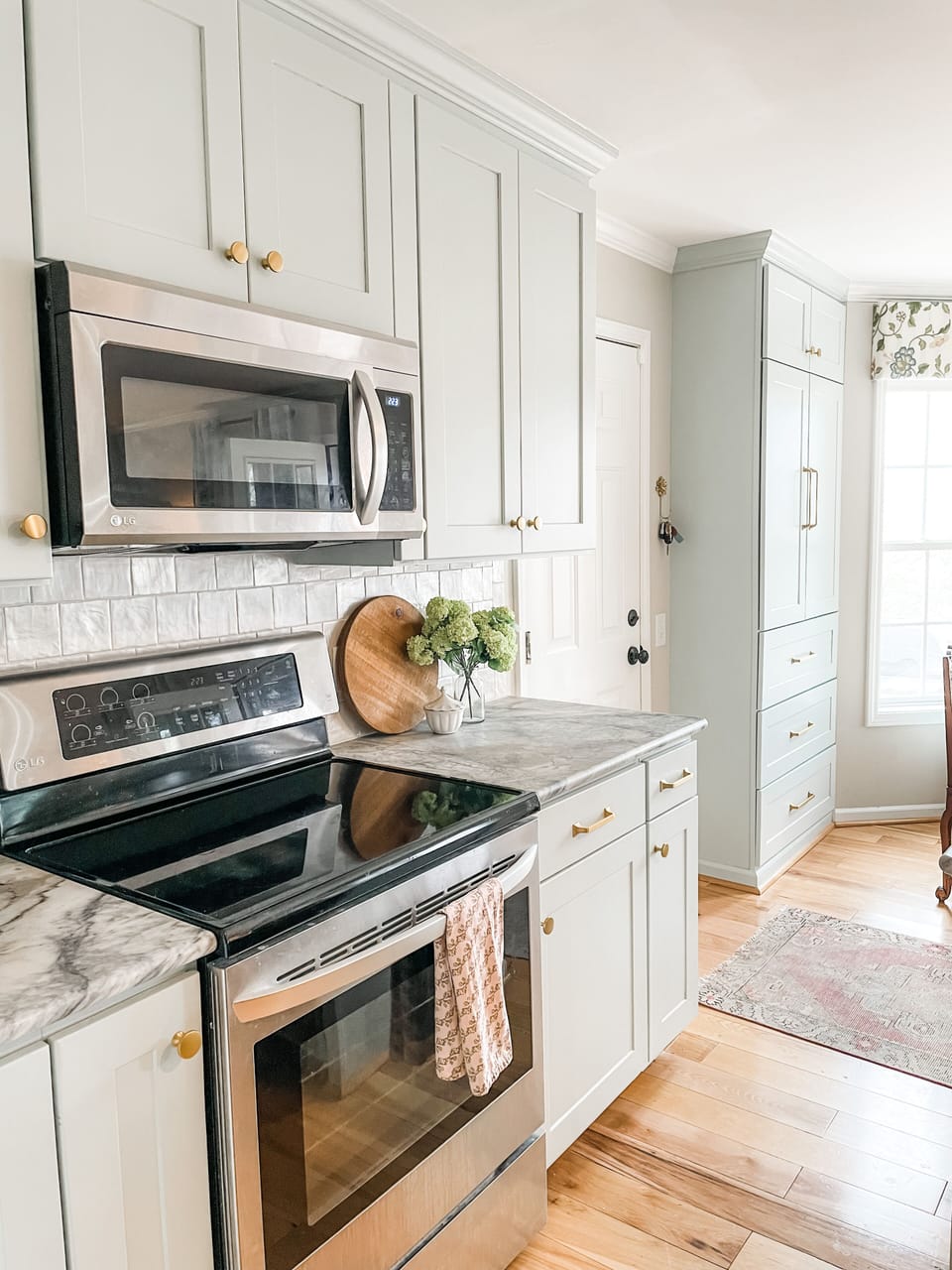 Modern kitchen with sleek appliances, marble counters, and a bright, inviting design.