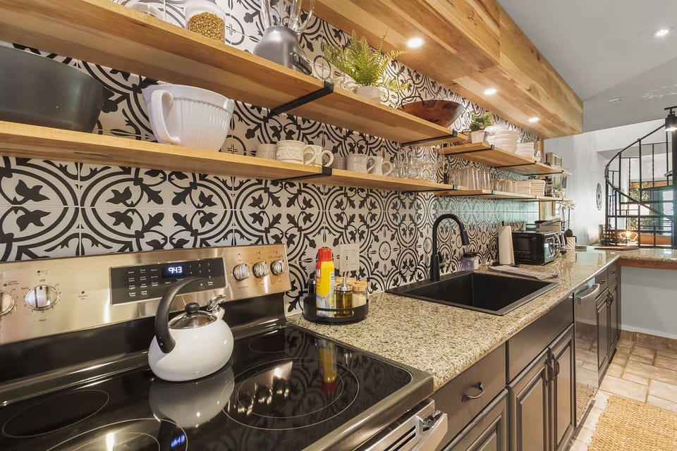 Renovated Chef's Kitchen — Sleek finishes, a black farmhouse sink, and stainless appliances—modern, elevated, and made for real cooking (or just looking fabulous). 🍳💡