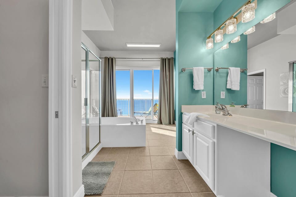 Luxurious master bathroom with ocean views, dual vanities, and glass shower - your private sanctuary with stunning sea vistas.