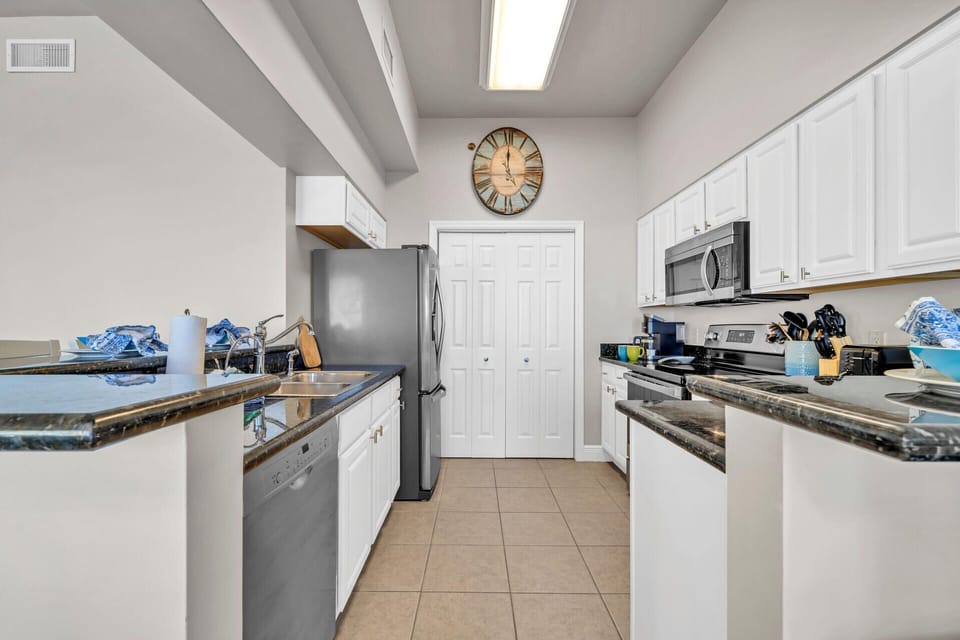 Your fully equipped galley kitchen features granite countertops, stainless steel appliances, and everything needed to prepare memorable meals during your stay.