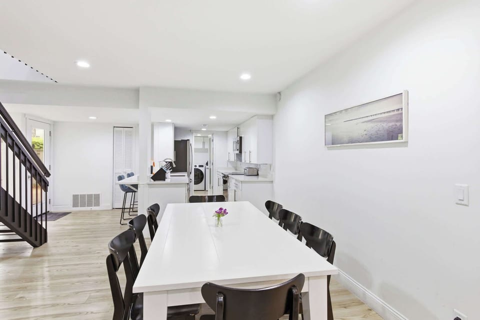 Modern dining area with seating for ten and an open kitchen layout