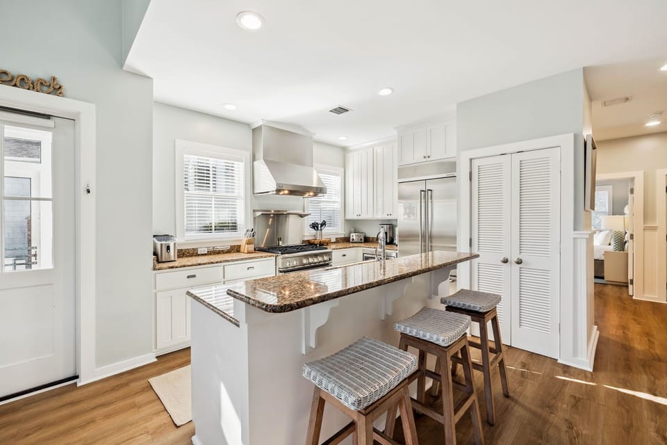 Your gourmet kitchen awaits with granite counters, stainless appliances, and a breakfast bar where morning coffee tastes even better.