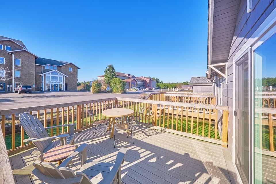 Roomy private deck, complete with a table and chairs, allowing you to access the yard and barbecue area.