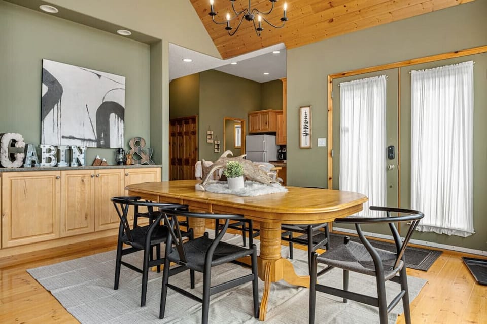 Dining area with seating for 6 at the table and 3 at the kitchen island.