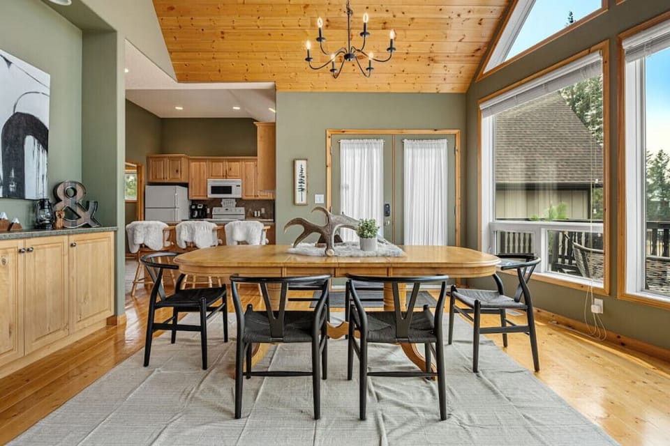 Dining area with seating for 6 at the table and 3 at the kitchen island.