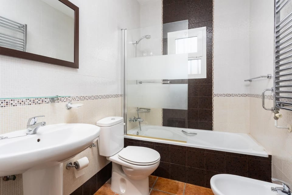 En suite bathroom with bath and shower