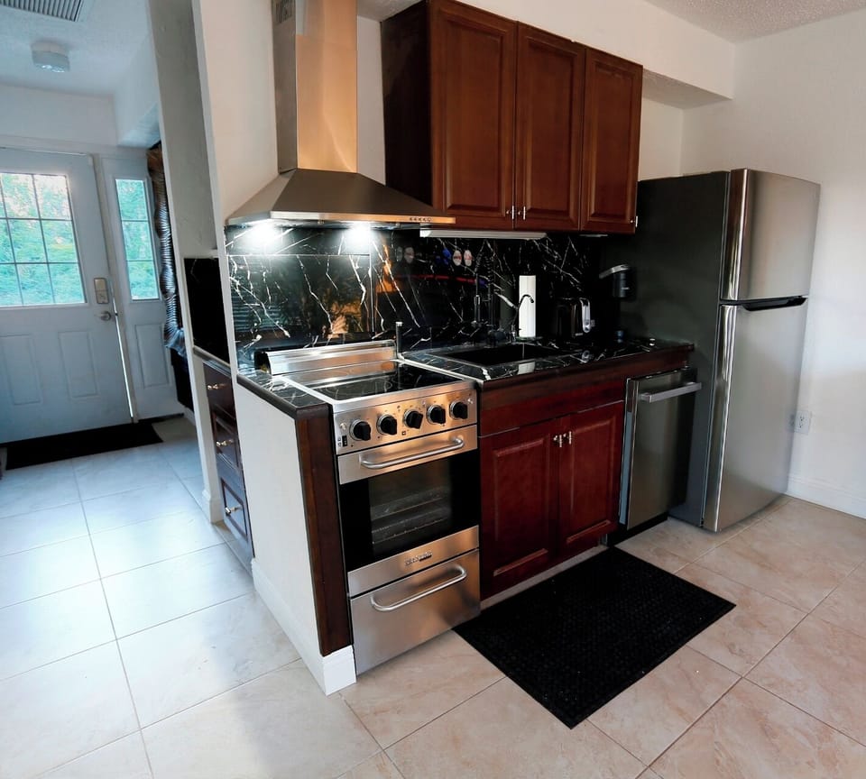 Kitchen looking towards the entrance with laundry room on the left