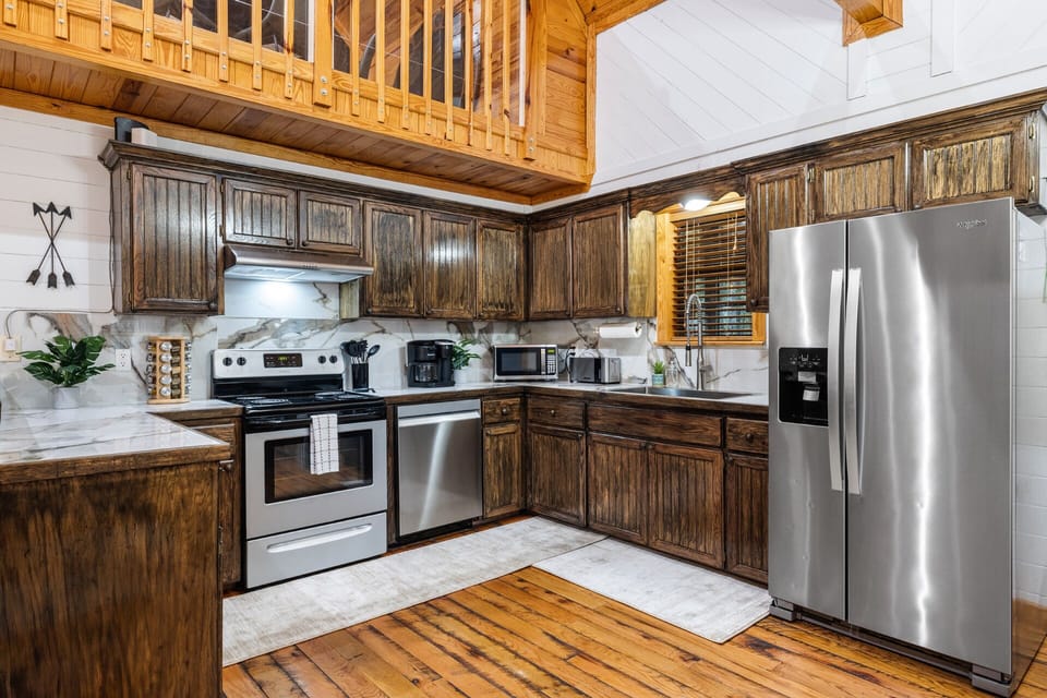 Stainless steel appliances; updated porcelain tile countertops for a chic flare.