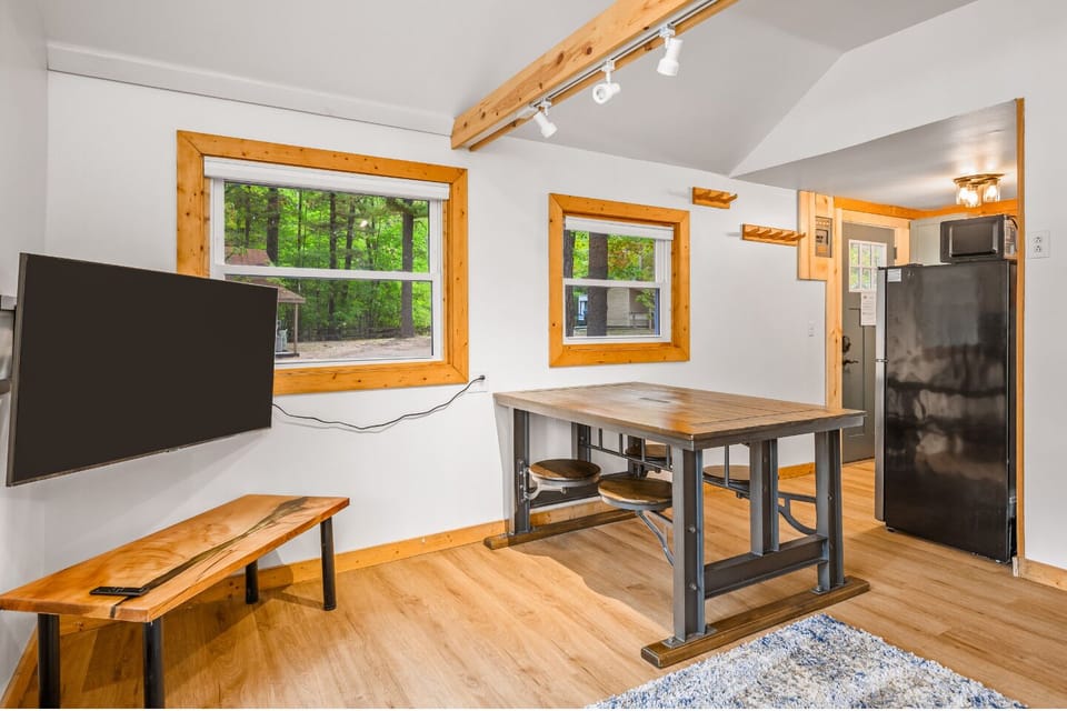 Bright space with a rustic table and views of the lush Michigan woods!