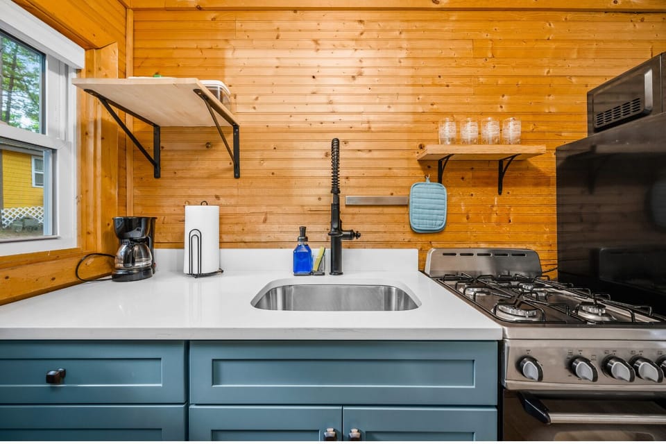 Kitchen: Modern charm meets functionality with sleek appliances and warm wood accents!