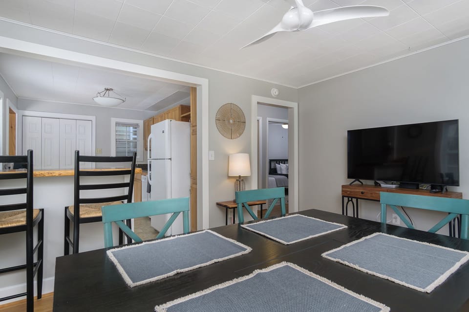 Dining area with seating for up to 6 & 50" smart TV (streaming only).