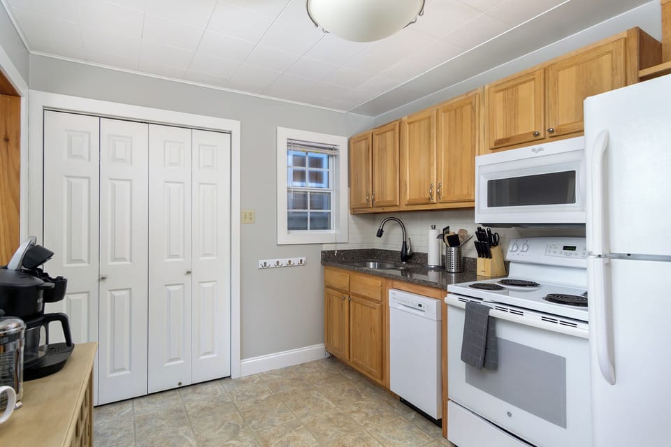 Kitchen with dishwasher & coffee station.