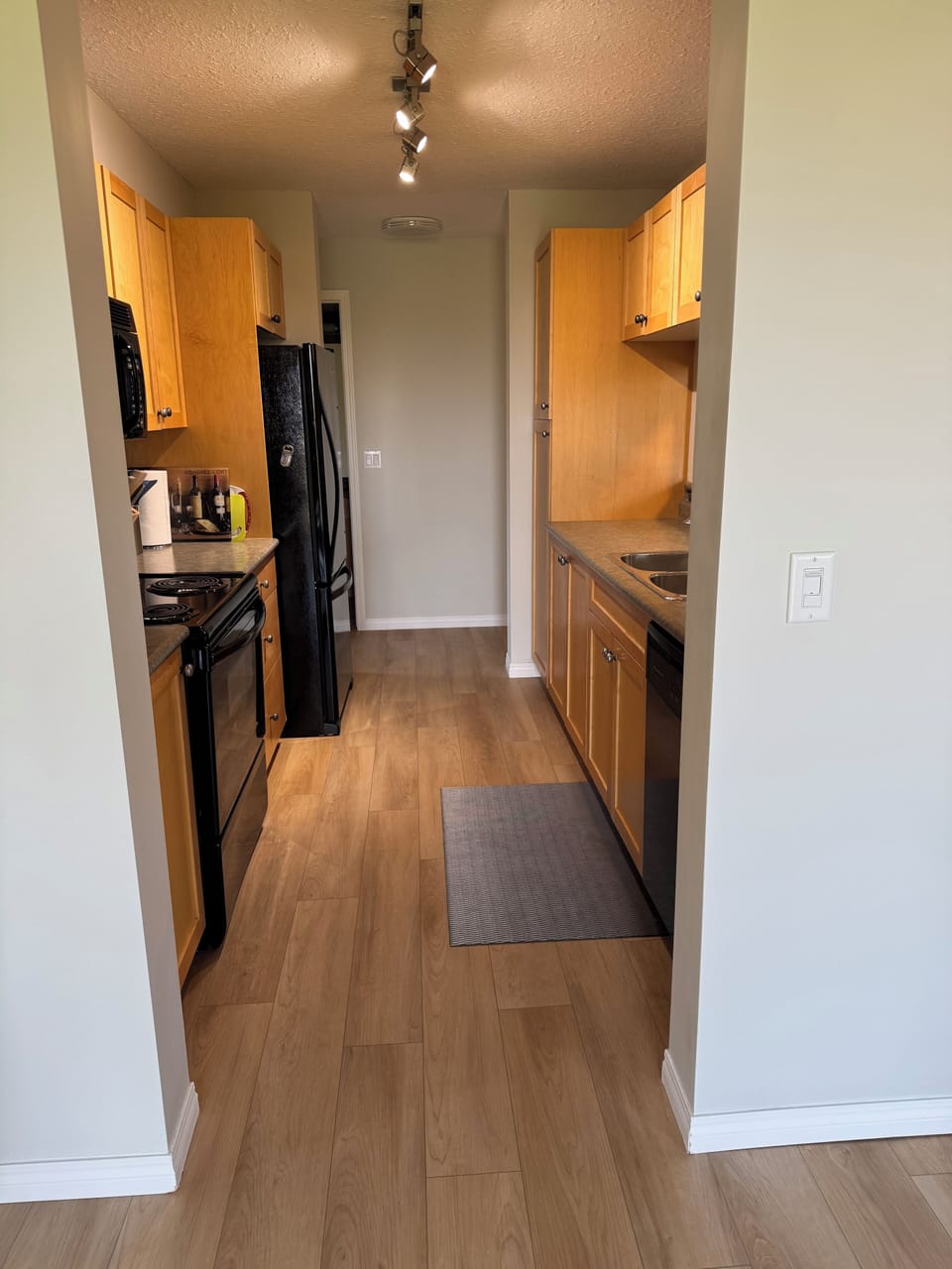 Walk through kitchen with necessities and all kitchen appliances