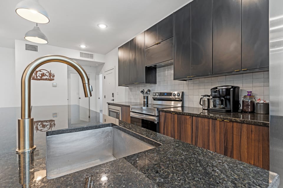 Fully equipped kitchen featuring ample counter space, modern cabinetry, and quality appliances, making extended stays and home-cooked meals simple and convenient.