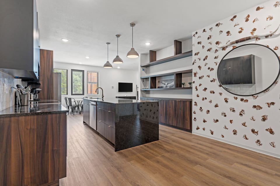 Open-concept kitchen with clean lines, modern finishes, and easy flow into the living space—ideal for entertaining or relaxing after exploring nearby shops and dining.