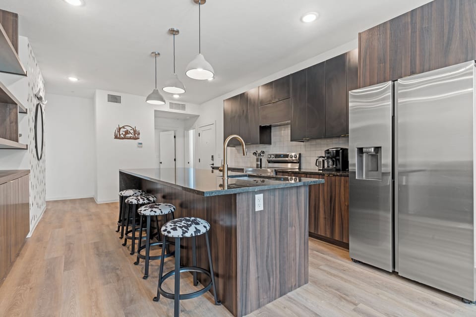 Spacious kitchen island with bar seating offers a casual spot for breakfast, coffee, or conversation. Designed for comfort and functionality in this stylish apartment community.