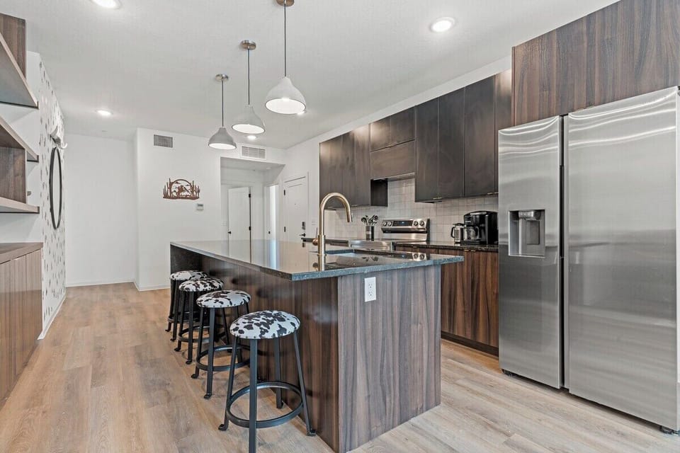 Spacious kitchen island with bar seating offers a casual spot for breakfast, coffee, or conversation. Designed for comfort and functionality in this stylish apartment community.