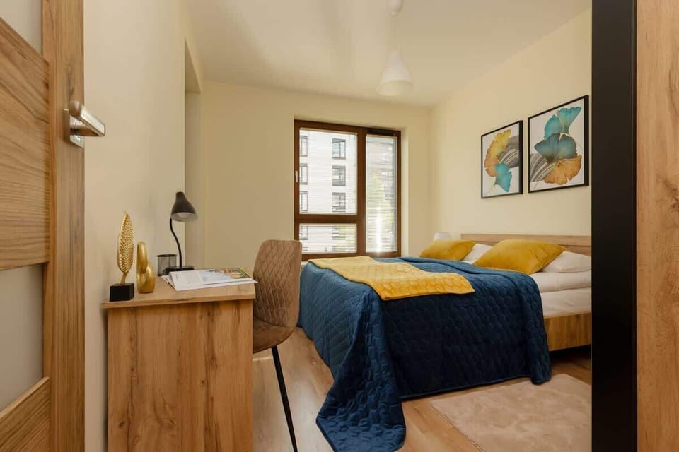 A different perspective of the bedroom, highlighting the desk area and window.
