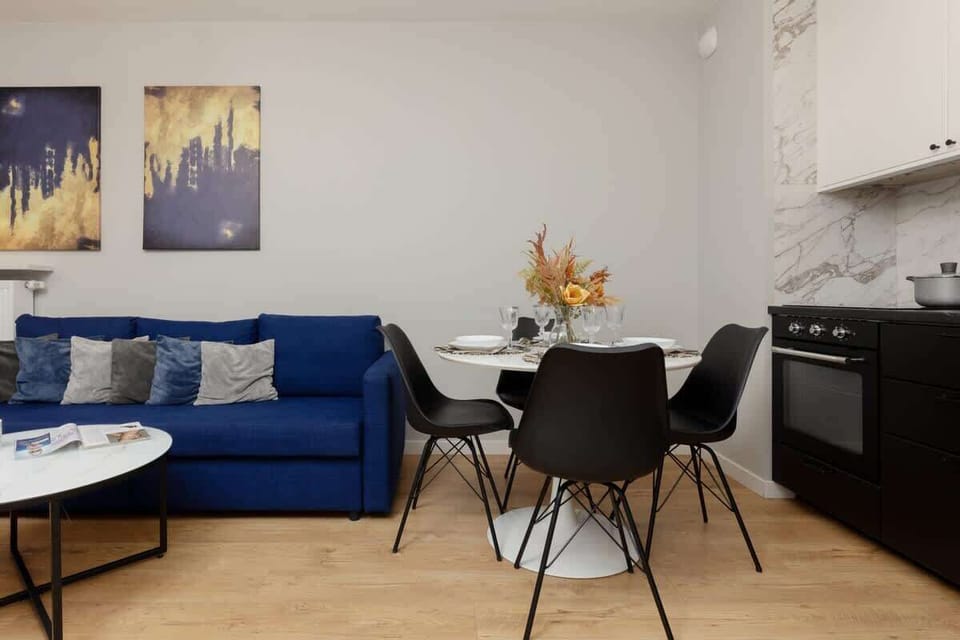 Another perspective of the lounge and dining area, highlighting contemporary artwork and abundant natural light.


