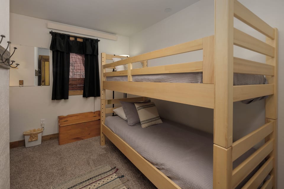 Your cozy bunk room features sturdy wooden beds with comfortable linens, perfect for shared adventures.
