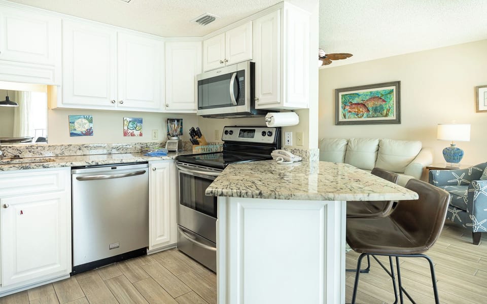 Smooth granite breakfast bar seats you for casual chats while meals simmer on the stove in your kitchen