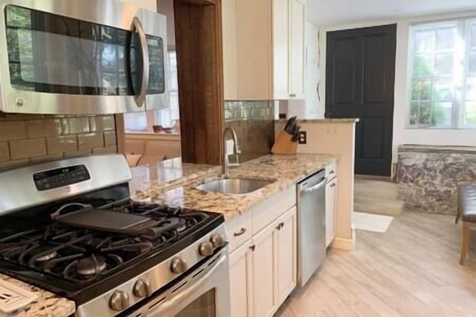 Full Kitchen with View of Entrance Into Unit