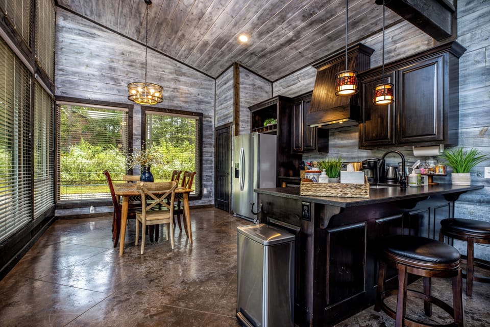 Kitchen and dining room with a refrigerator, oven/stove, microwave, dishwasher, and coffee maker.