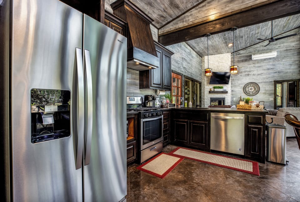 Kitchen with a refrigerator, oven/stove, microwave, dishwasher, and coffee maker.