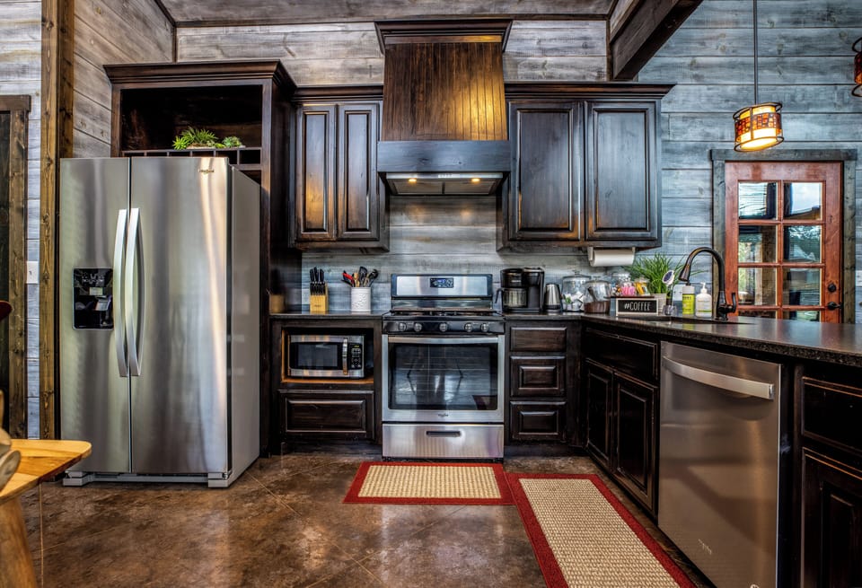 Kitchen with a refrigerator, oven/stove, microwave, dishwasher, and coffee maker.