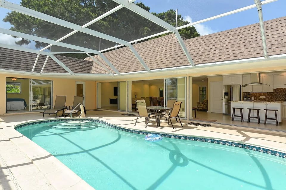 Private heated pool with deck chairs and loungers