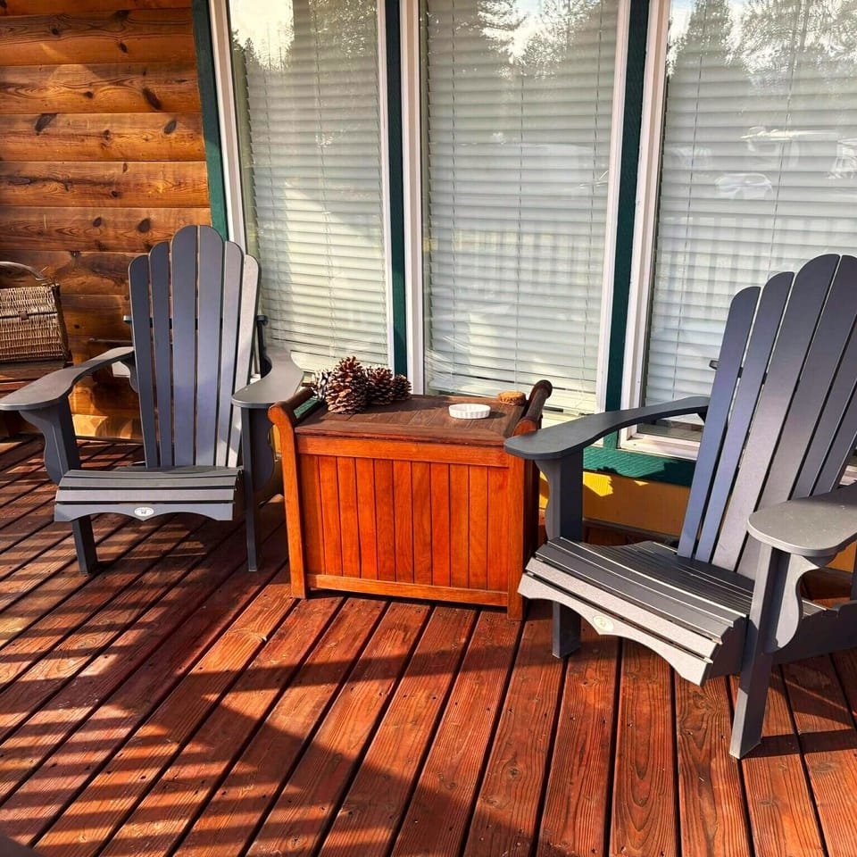Our covered porch, featuring a picnic table and a wooden roof, is the perfect spot to dine outdoors. Stay protected from sun and rain while enjoying lush greenery and fresh air. It’s the ultimate setting for a peaceful meal in nature.