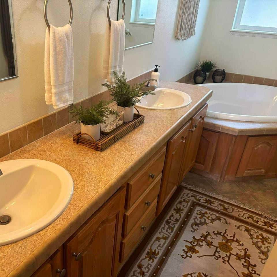 Indulge in our luxurious master bath, designed for relaxation with a spacious walk-in shower and a deep, oversized soaking tub. With double sinks and ample room to prep for the day, this spa-like retreat offers the perfect blend of style and comfort.