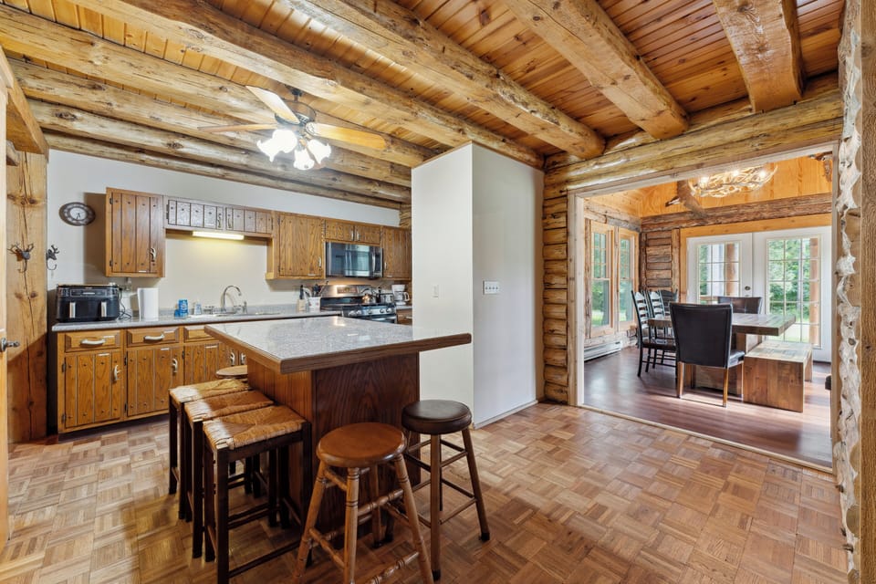 The lodge kitchen has a microwave, dishwasher, stove, fridge, Keurig