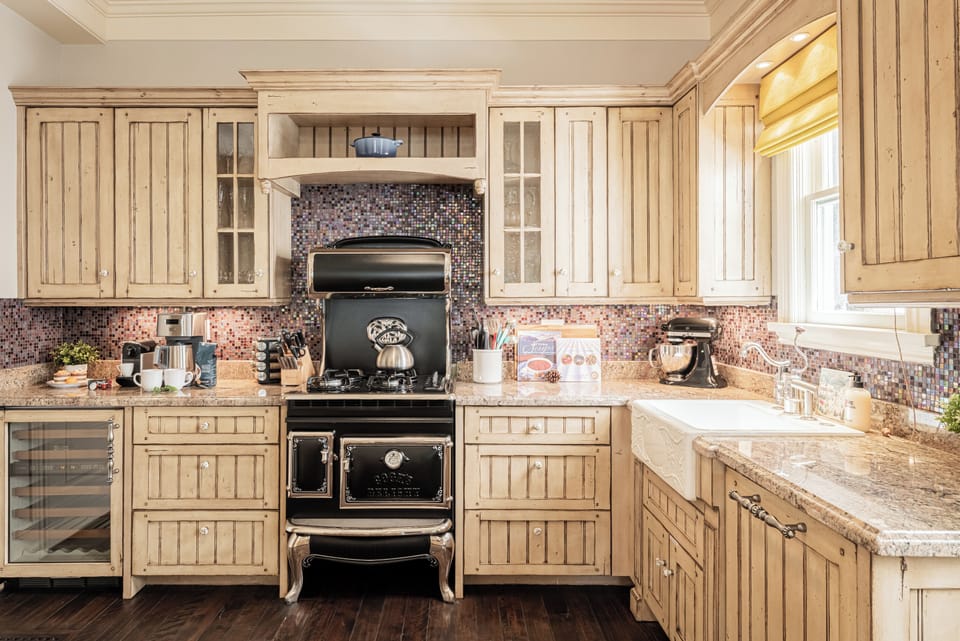 Gas range with an antique stove door facade