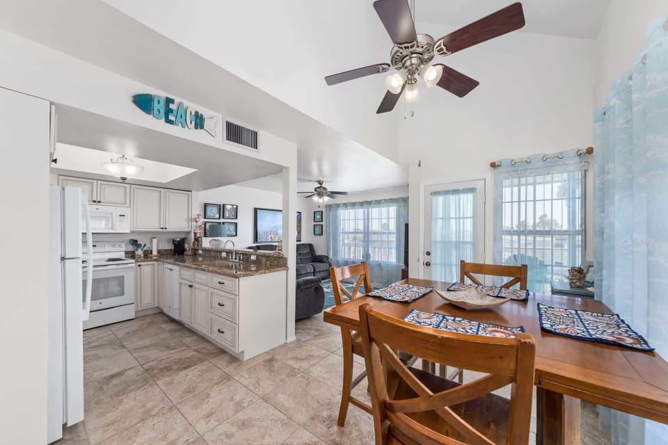 The kitchen opens to the dining area and water views