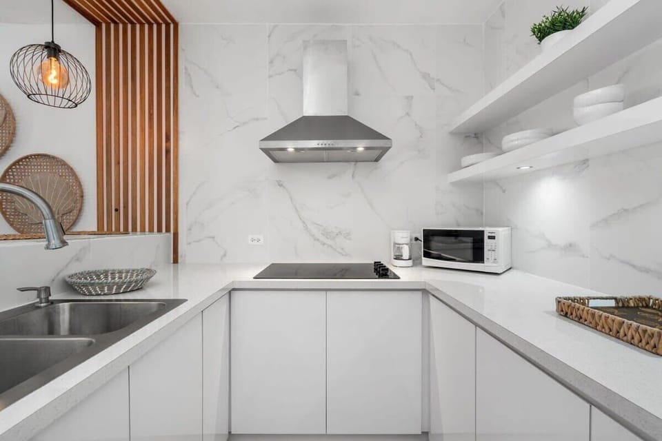 The modern and eclectic kitchen is fully equipped for an extended stay
