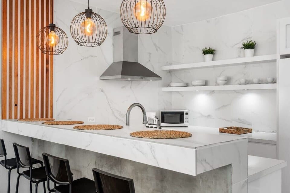 The modern and eclectic kitchen is fully equipped for an extended stay