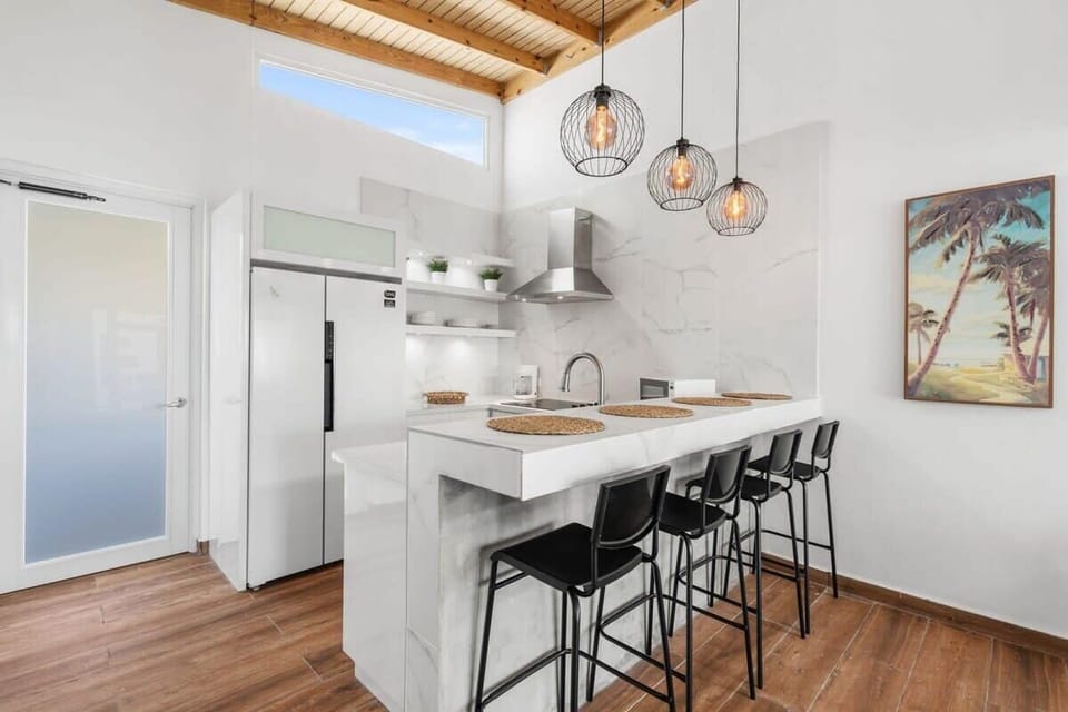 The fully renovated kitchen has an island with seating for 4 guests.