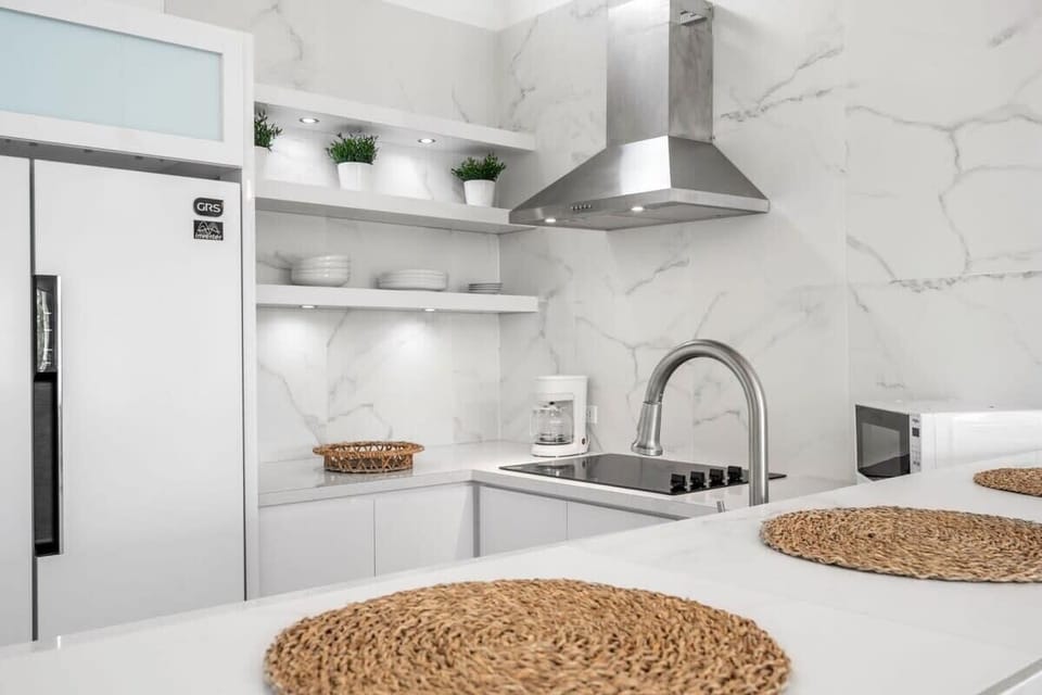 The fully equipped kitchen has a clean modern look