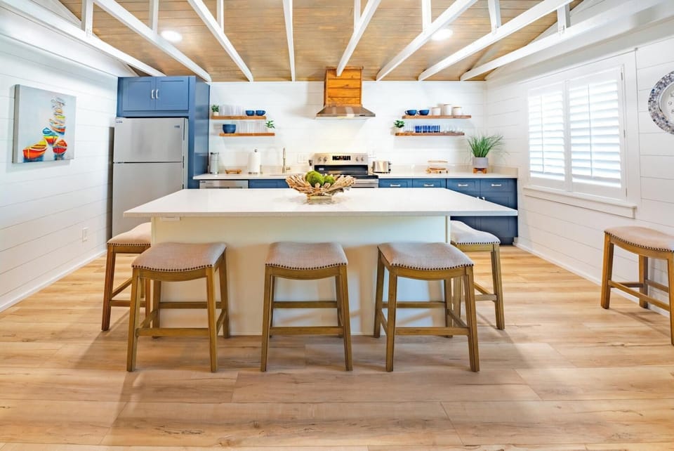 Modern kitchen with a large island and blue cabinetry for family-friendly gatherings