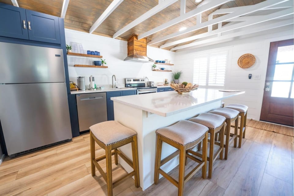 Modern kitchen with a large island and seating for five.