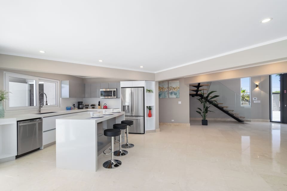Chic Kitchen Area of the Villa in Noord Aruba - Integrated appliances for a seamless and stylish appearance - Fully Equipped - Open concept connecting the kitchen to the living area
