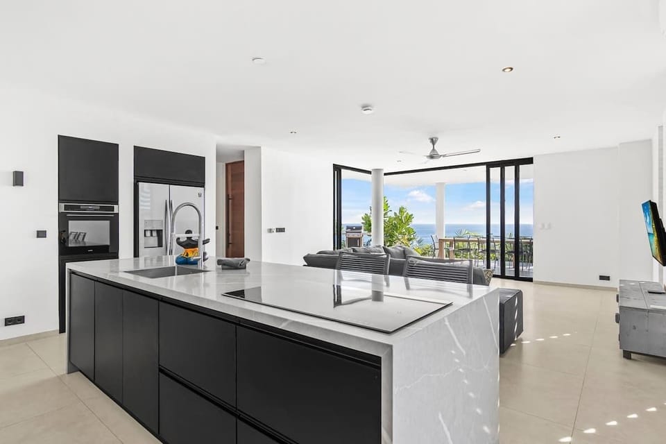 The sleek open kitchen is fully equipped for every occasion — whether you're cooking a family meal, enjoying breakfast with a view, or bringing in a private chef for something truly special. All with the Caribbean Sea as your backdrop.