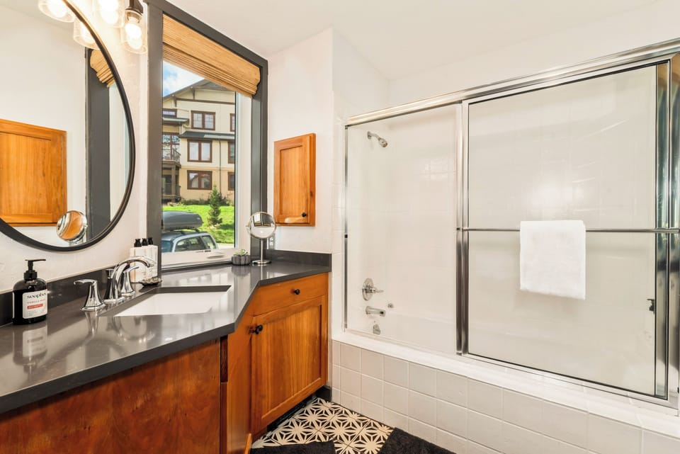 The main suite bath has a large vanity with lots of counter space, plus a tub and shower.