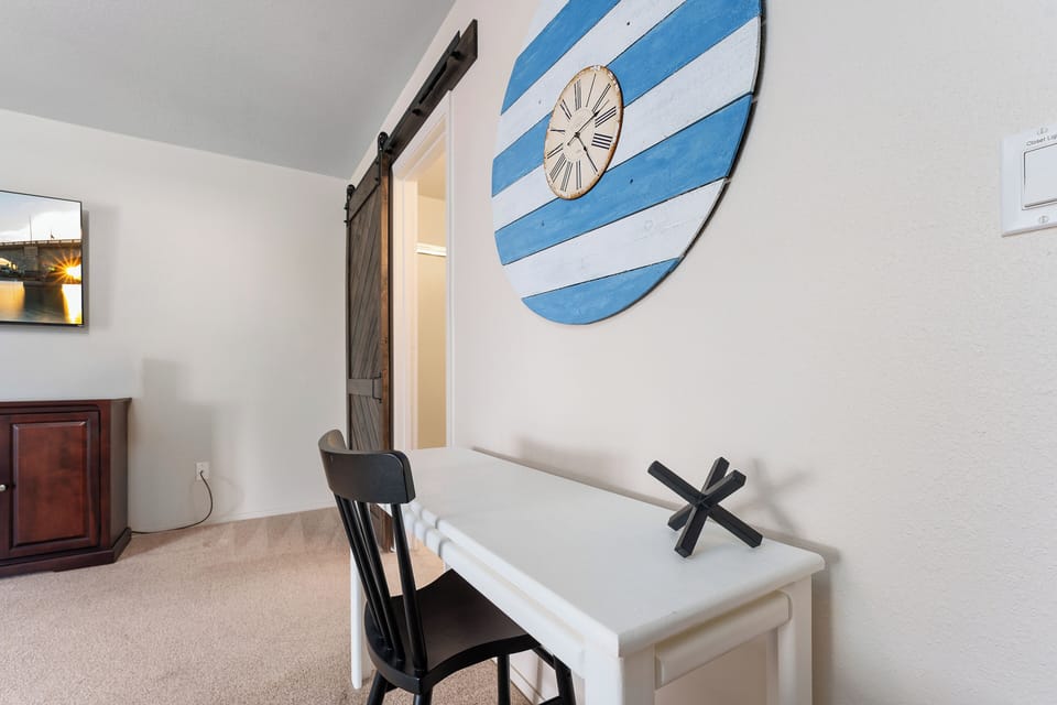 Aside from this night table there is a desk and rollaway chair for work needs.
